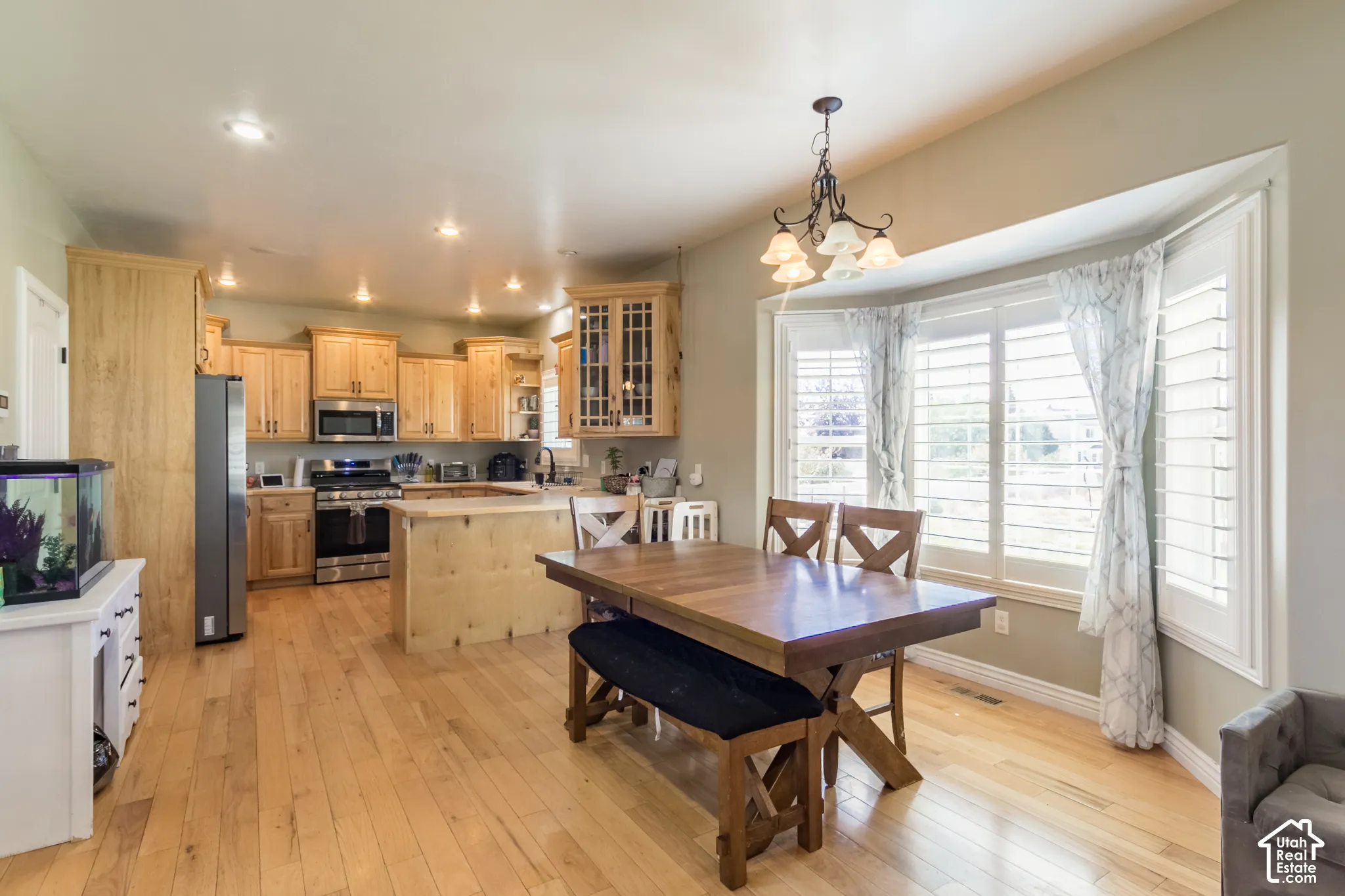 Kitchen with wood-finish flooring, recessed lighting, and light wood cabinetry