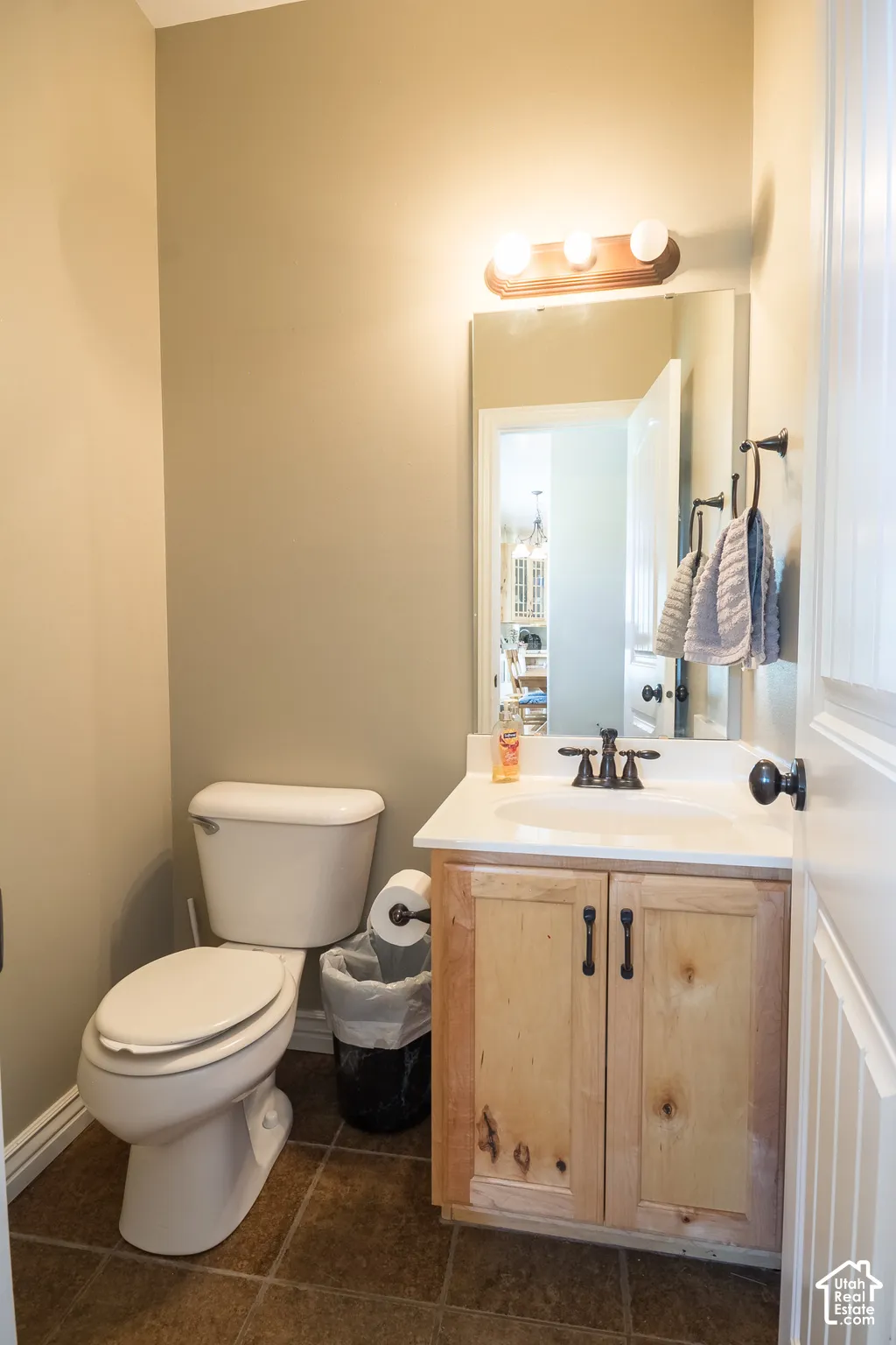 White toilet with tile flooring