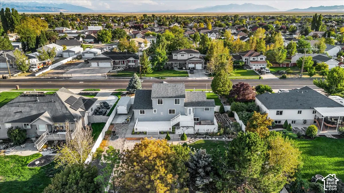 Two-story residence with a brick exterior, a multi-level deck, and a fenced perimeter