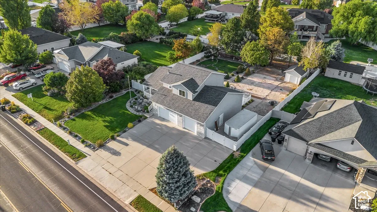 Spacious property featuring a multi-car driveway, attached 3-car garage, and a detached shed