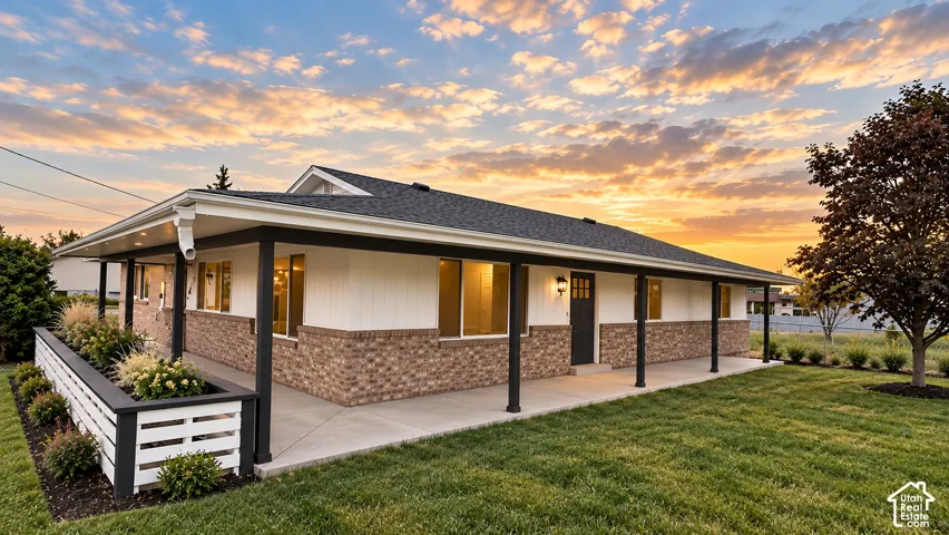 Digitally altered/rendered image for illustrative purposes only. Final finishes and appearance may vary. Floor plan is conceptual and not to scale. Single-story home featuring a covered front porch, brick and siding exterior, dark framed windows, and a da