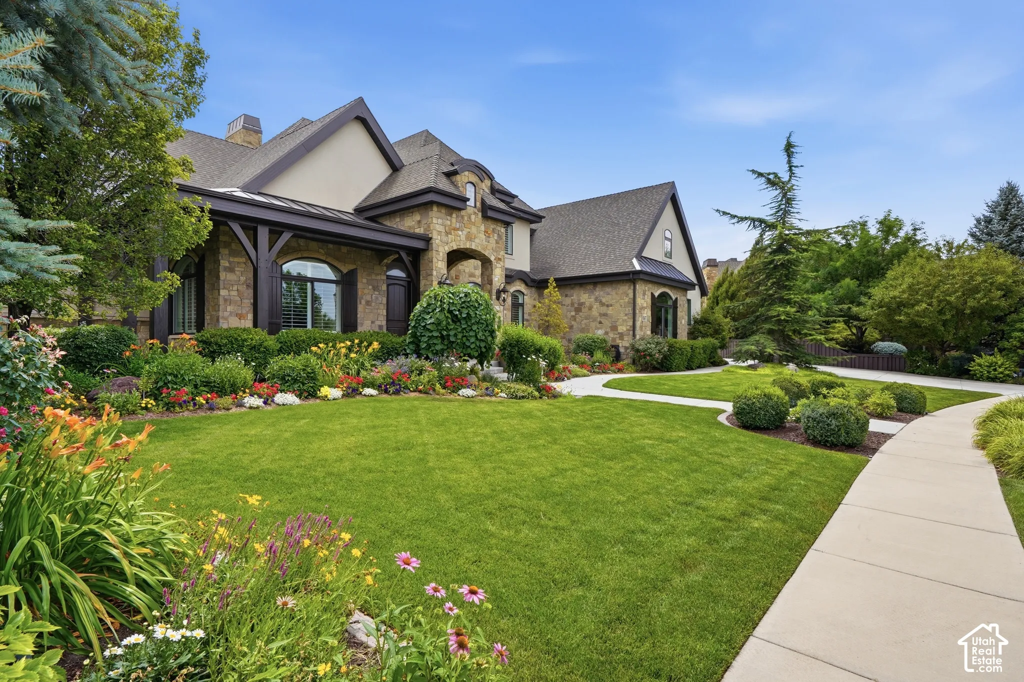 Stone and stucco exterior with dark trim accents