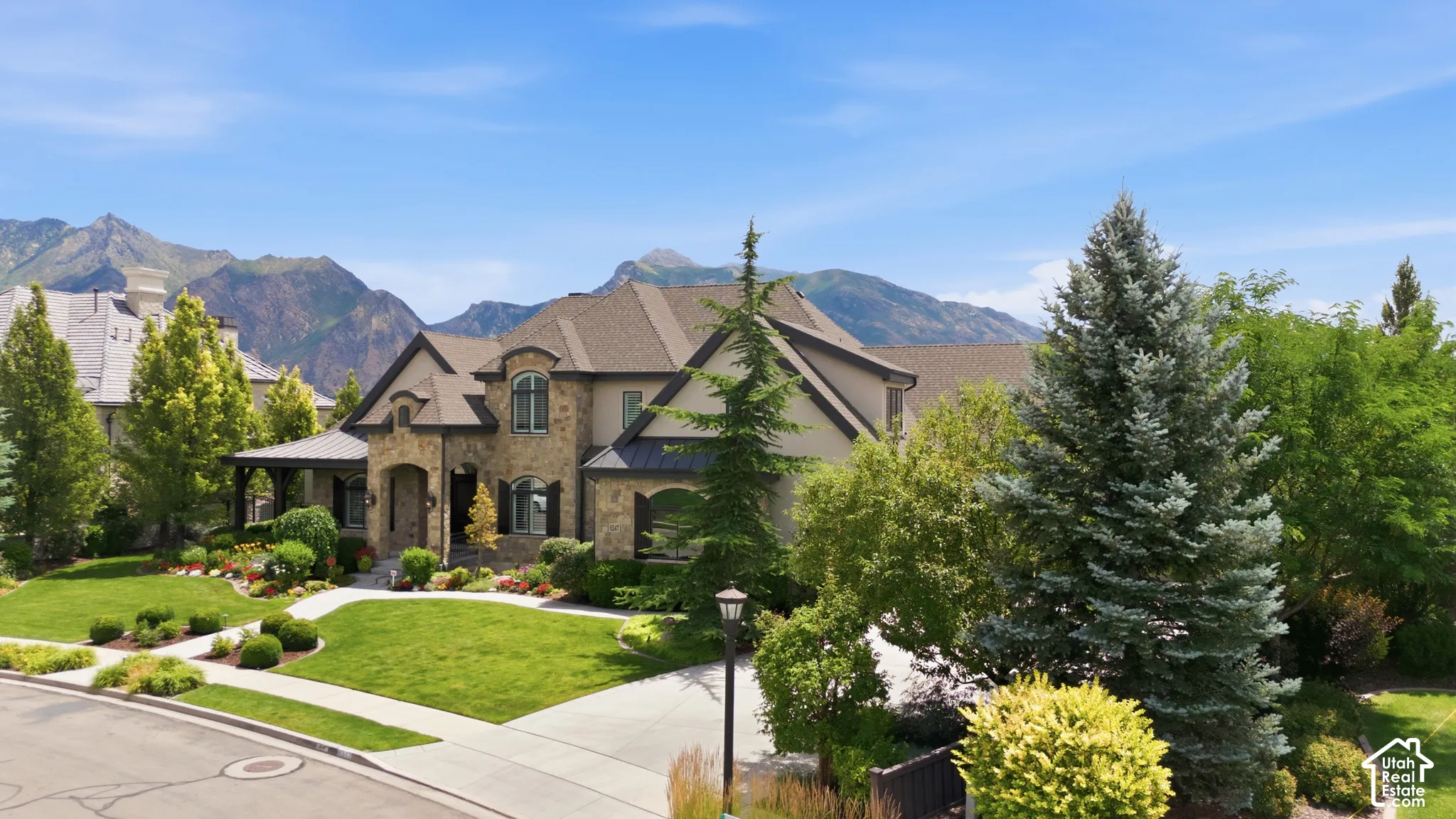 Stone and stucco exterior with a multi-gabled roofline