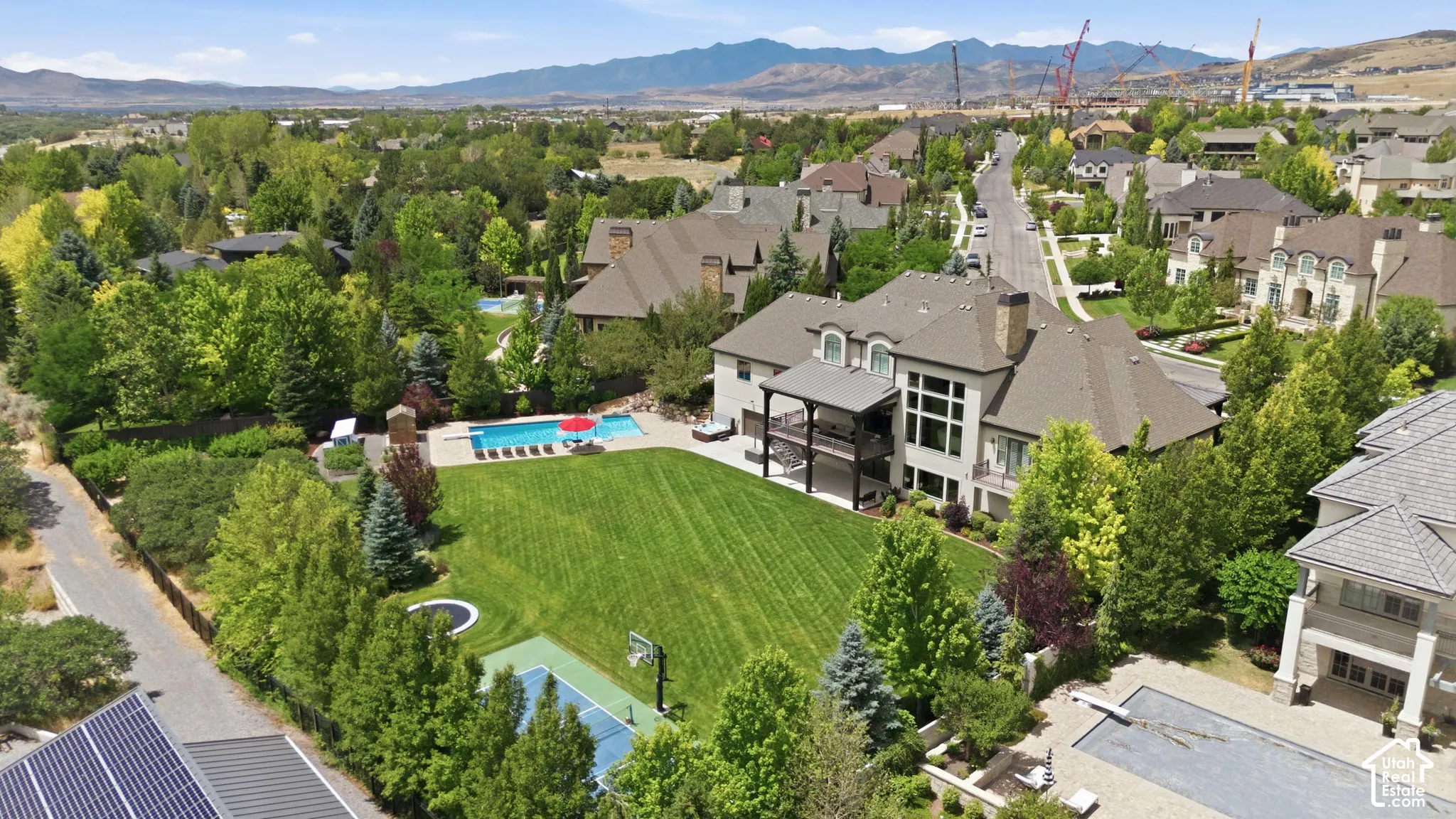 Spacious property featuring a large backyard, swimming pool, sports court, and a multi-level deck