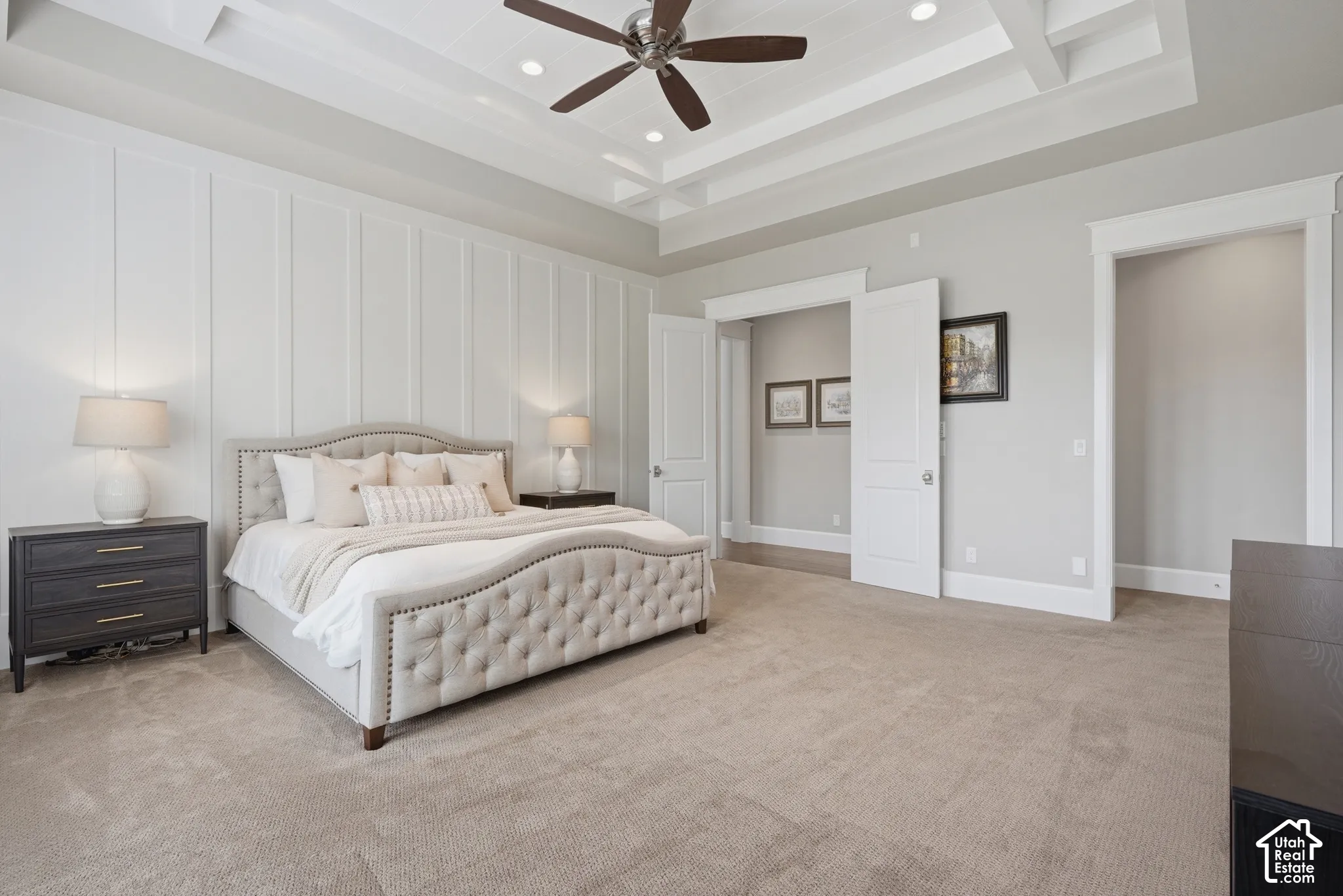 Tray ceiling with recessed lighting, ceiling fan, board and batten accent wall, and neutral carpet flooring
