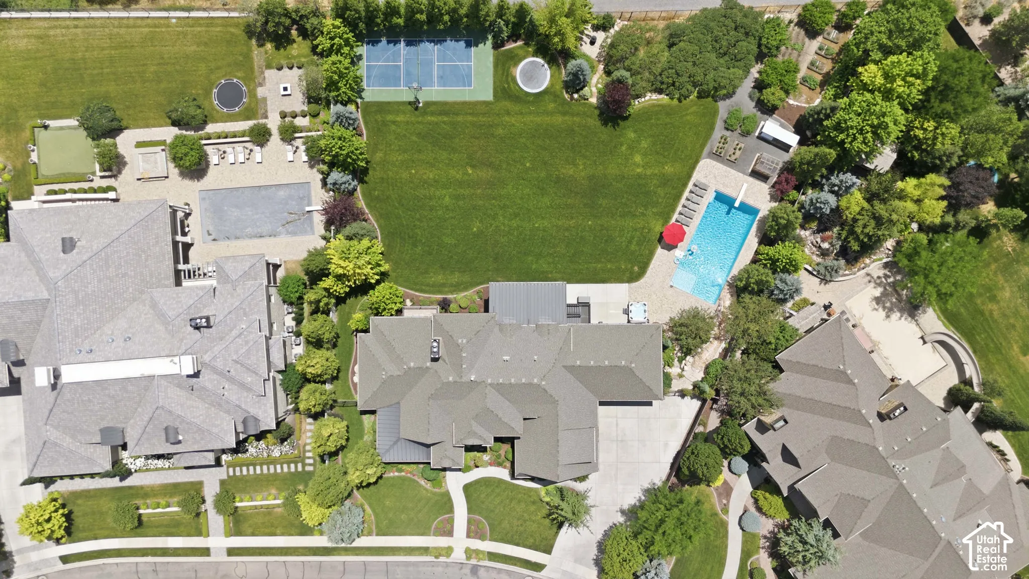 Expansive grounds featuring a full-size tennis court, swimming pool, and large landscaped lawn