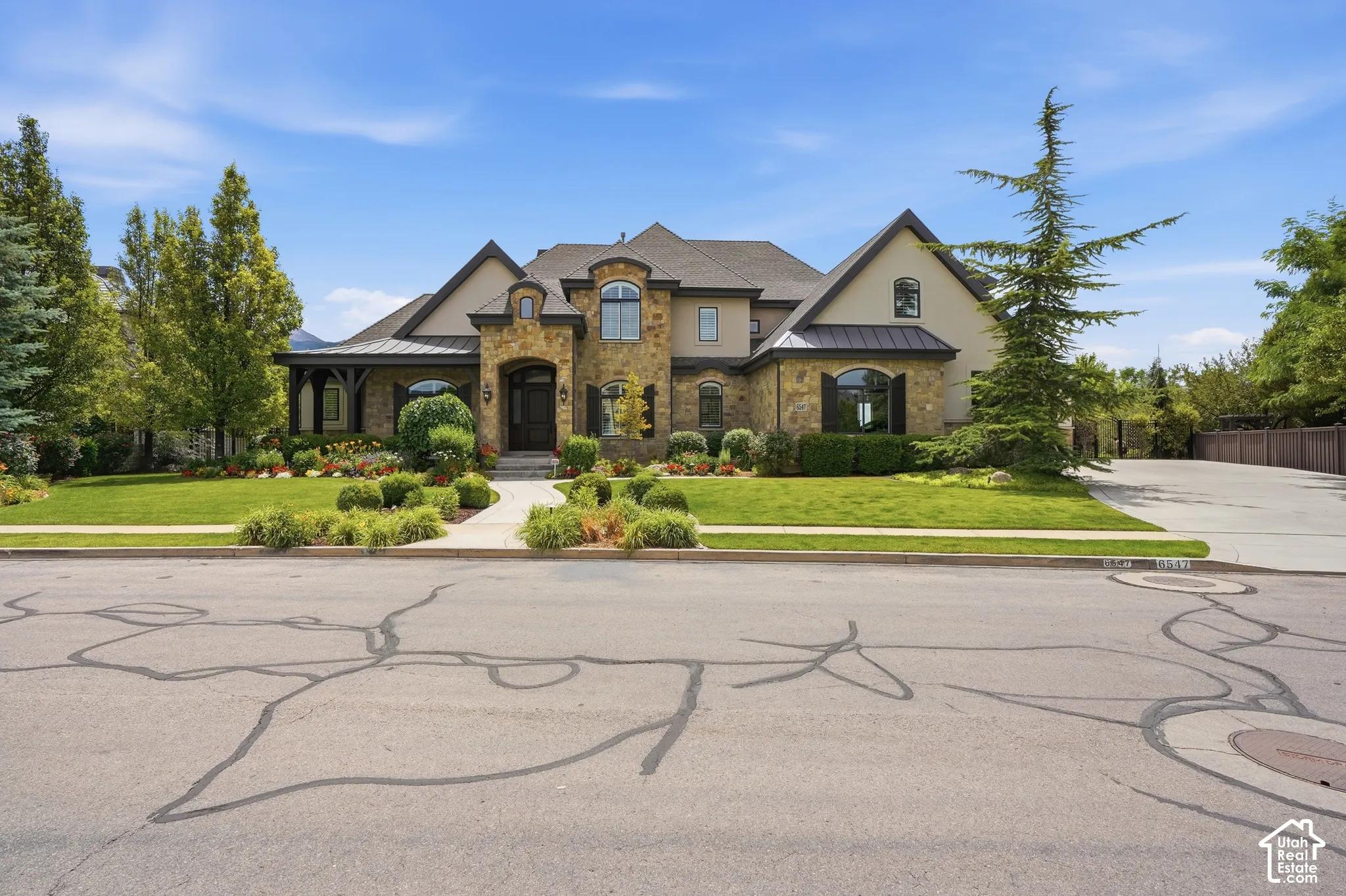 Stone and stucco exterior with dark trim accents