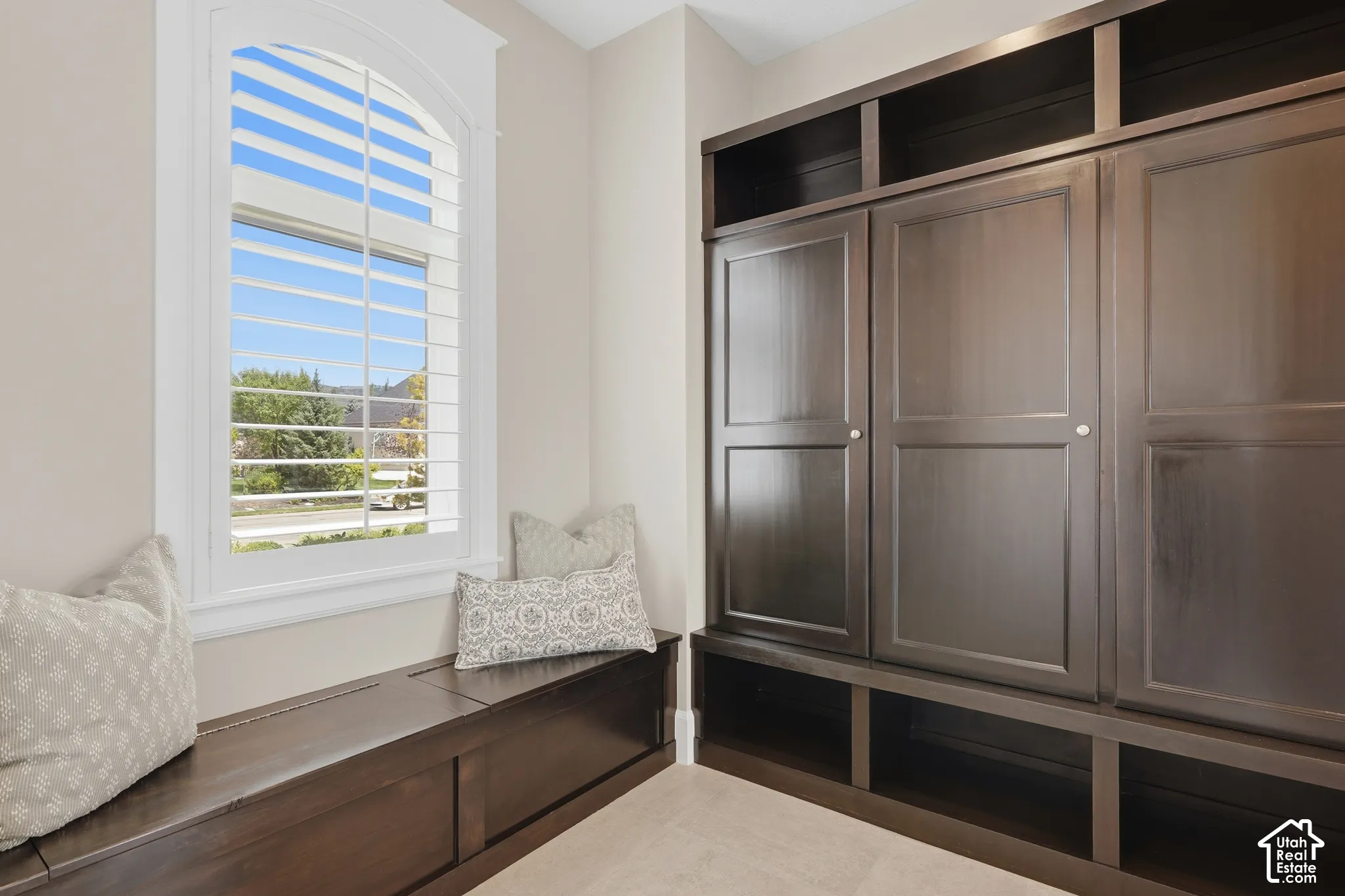 Built-in dark wood cabinetry with open shelving