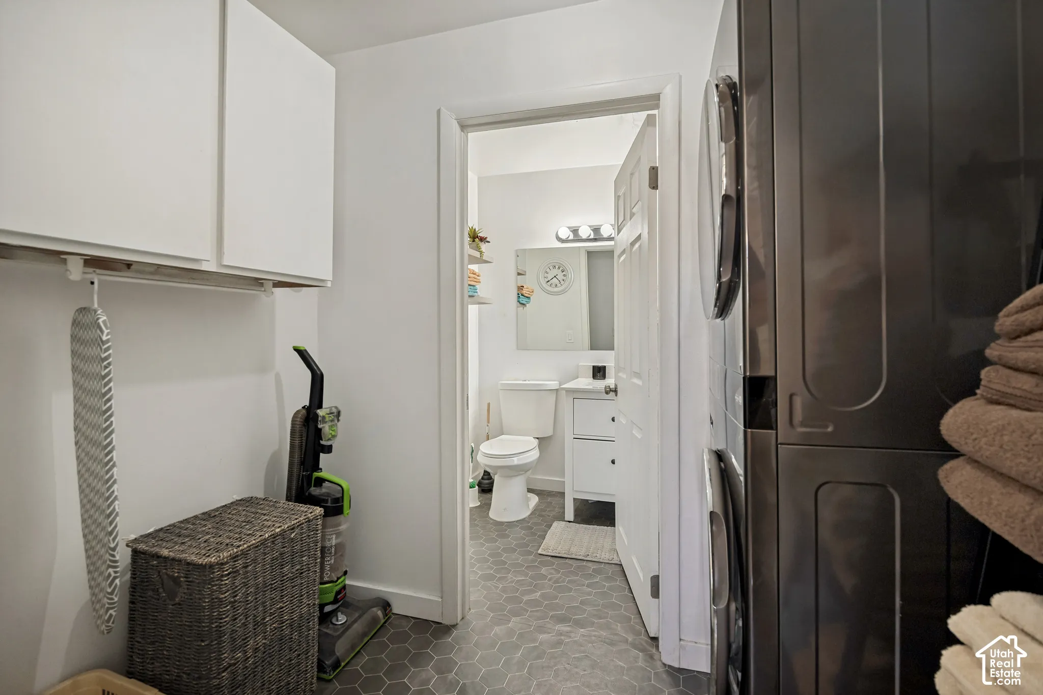 White upper cabinetry and hex tile flooring