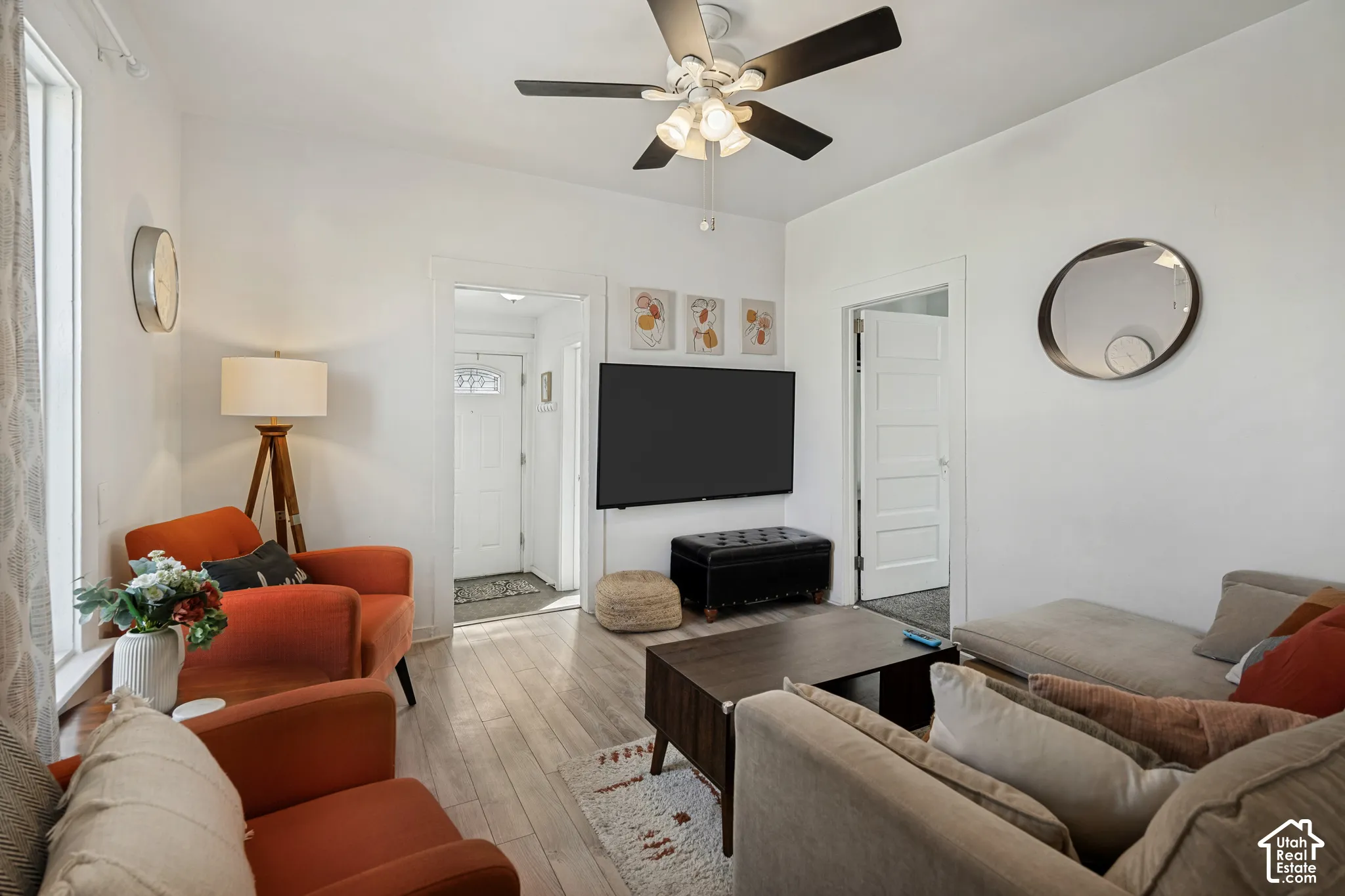 White walls and wood-finish flooring creating a bright interior