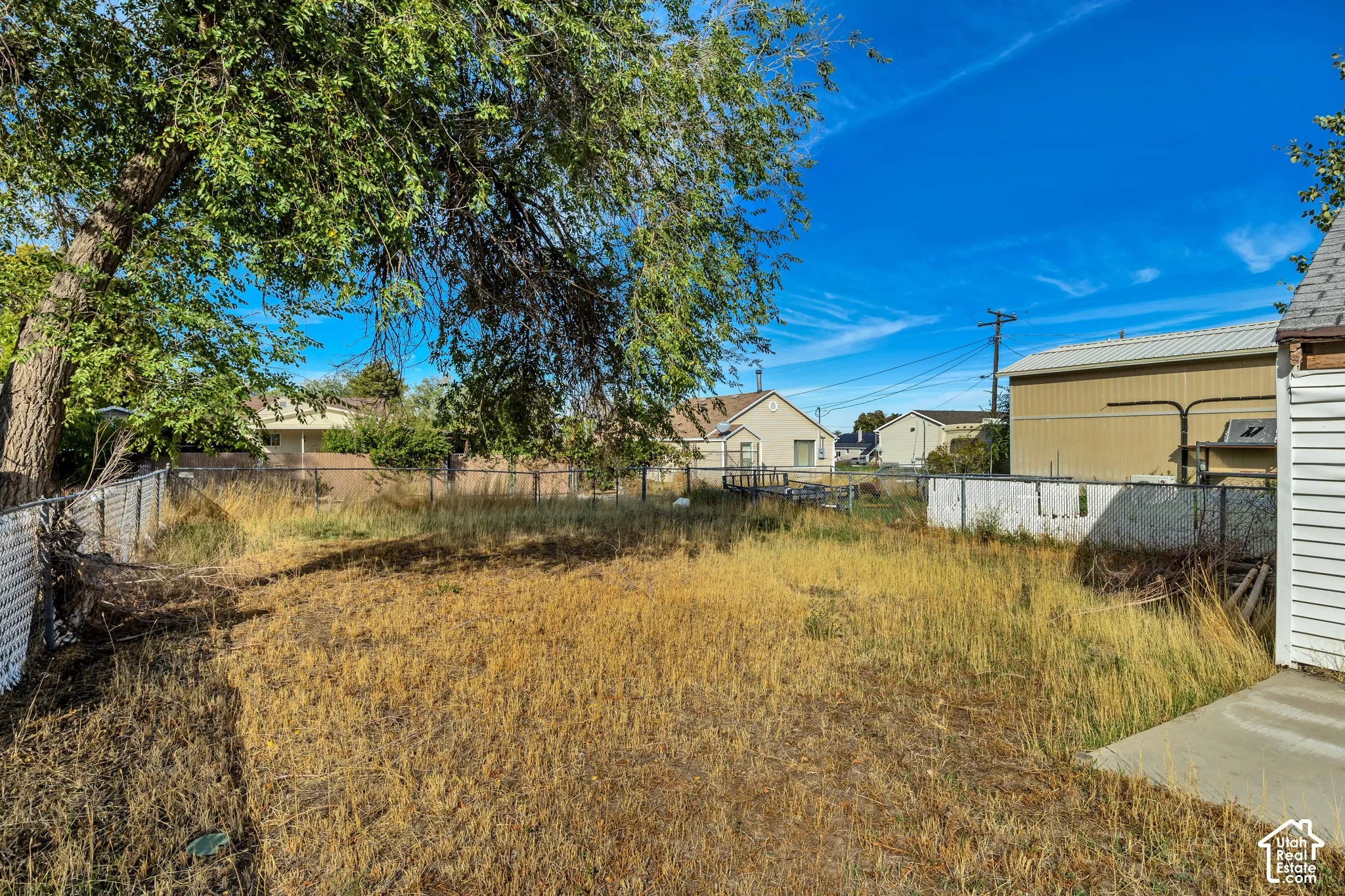 Expansive lot with established trees and partial perimeter fencing