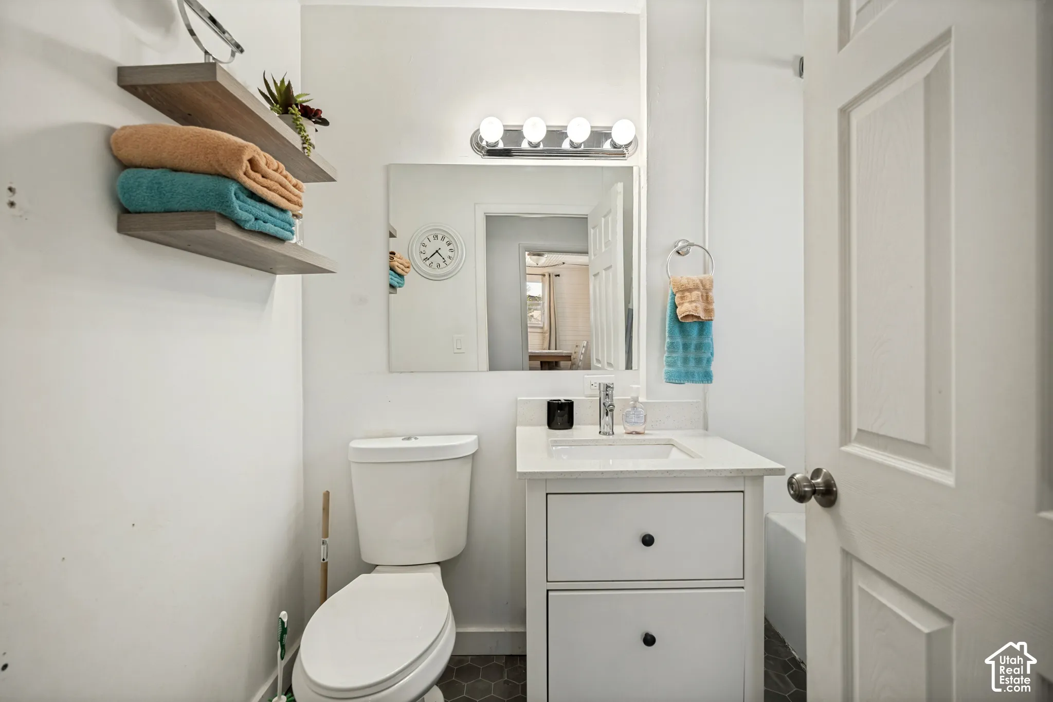 White vanity with rectangular basin and chrome faucet