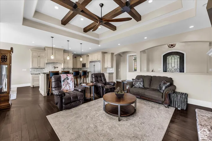 Tray ceiling with exposed wood-beam detailing and recessed lighting