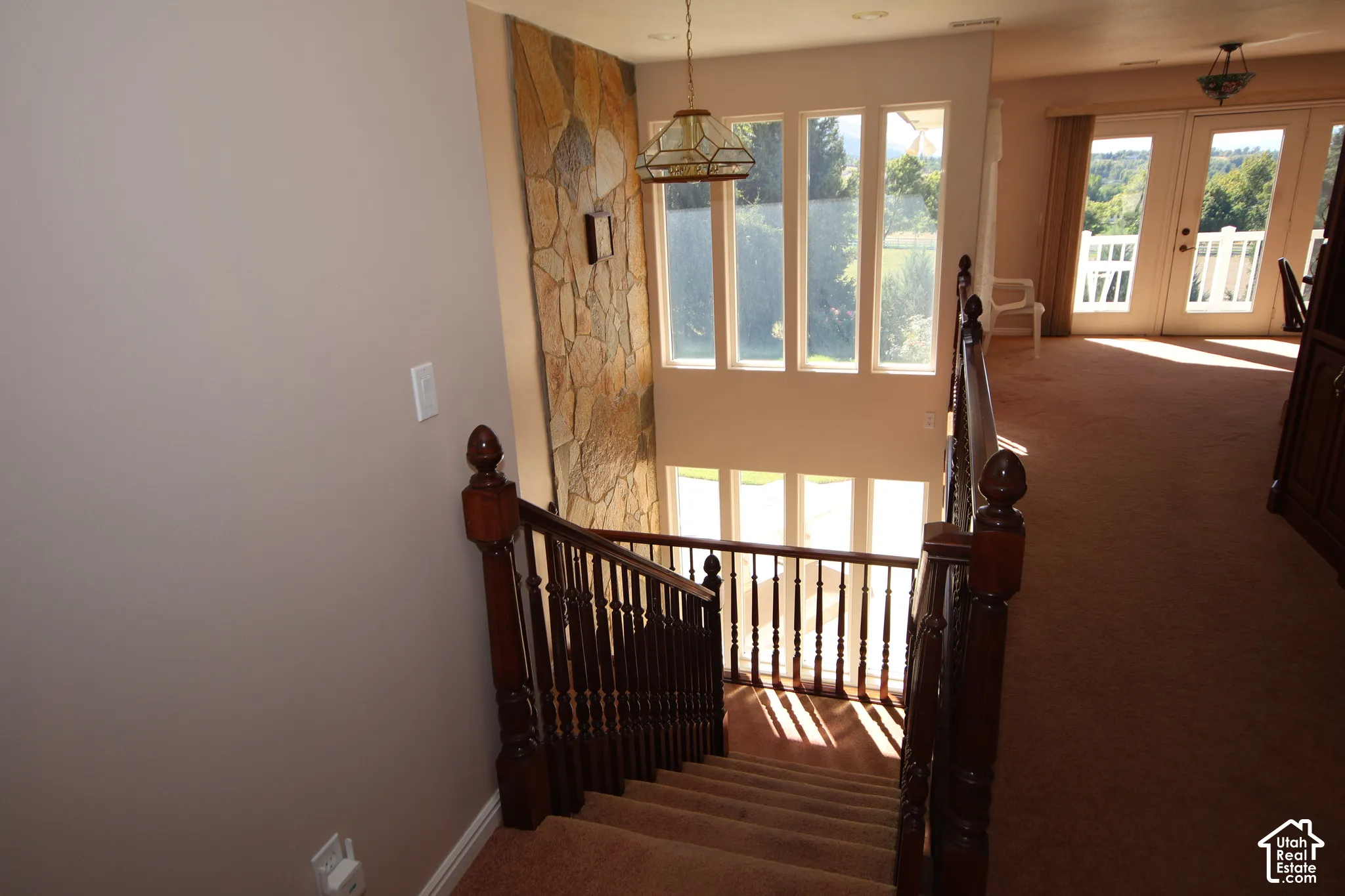 Two-story stone wall accent with a multi-pane window array