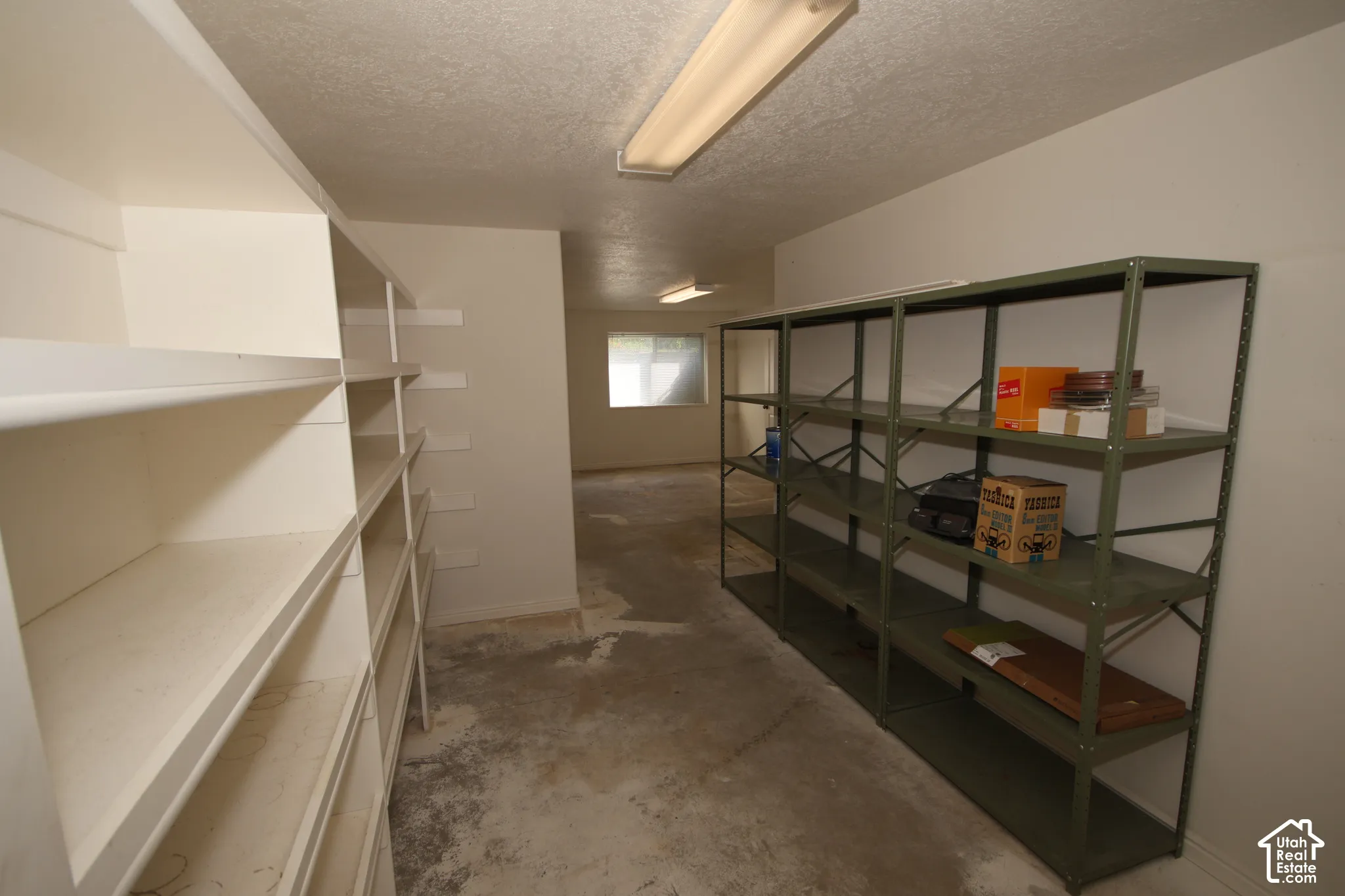 Extensive built-in shelving and additional metal shelving units provide significant storage capacity