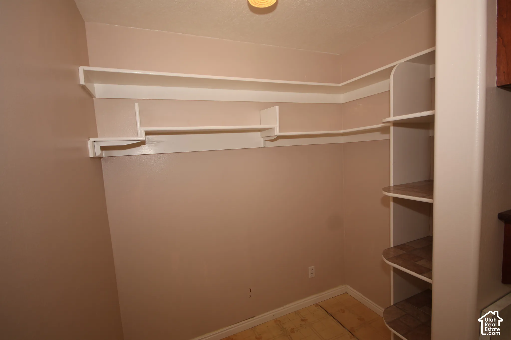 Built-in shelving, wall-mounted racks, rounded shelving, and natural wood flooring