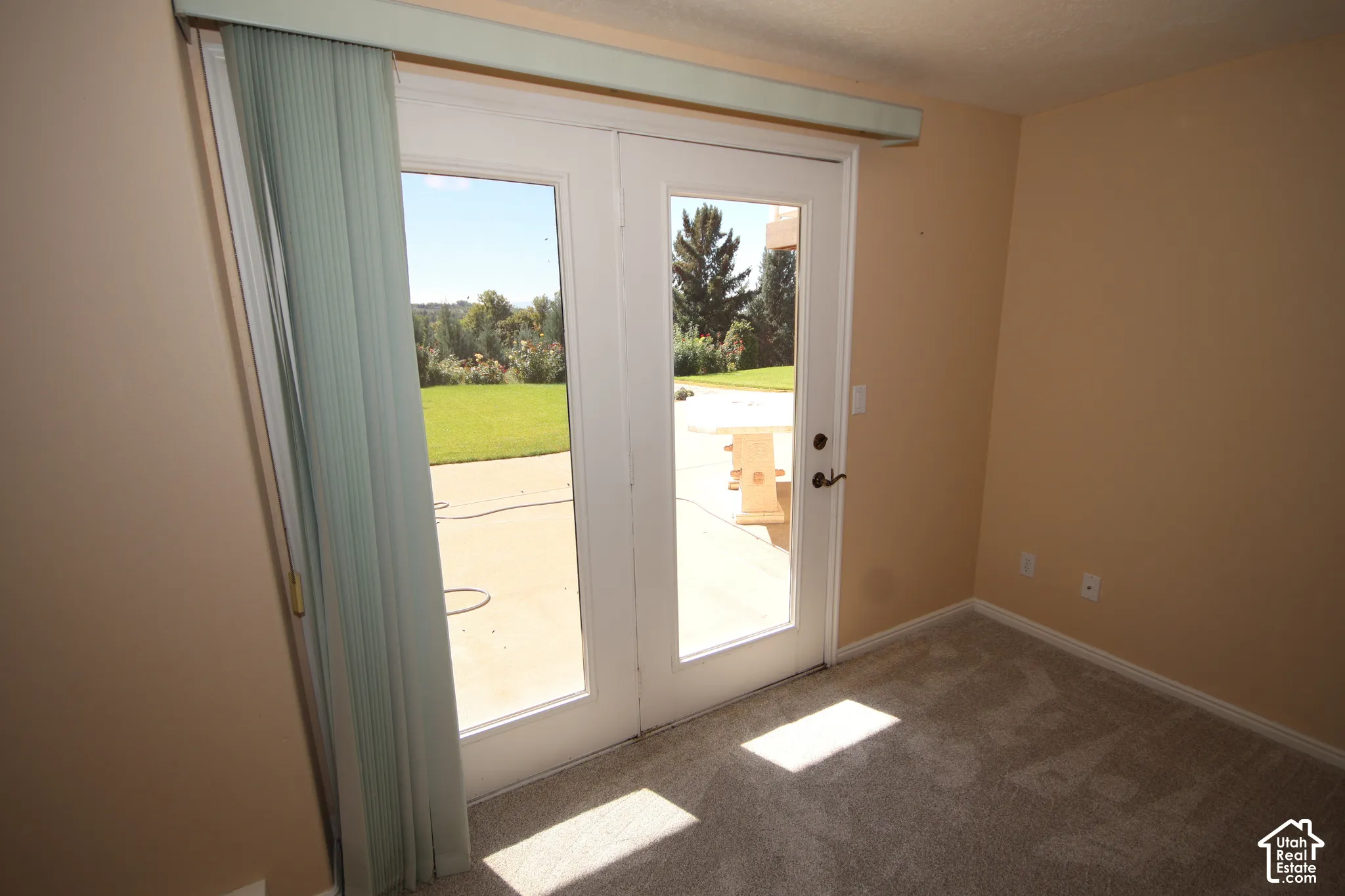 Glass-paneled French doors open to an outdoor patio area