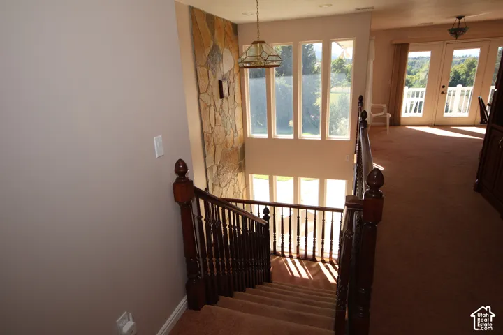 Two-story stone wall accent with a multi-pane window array