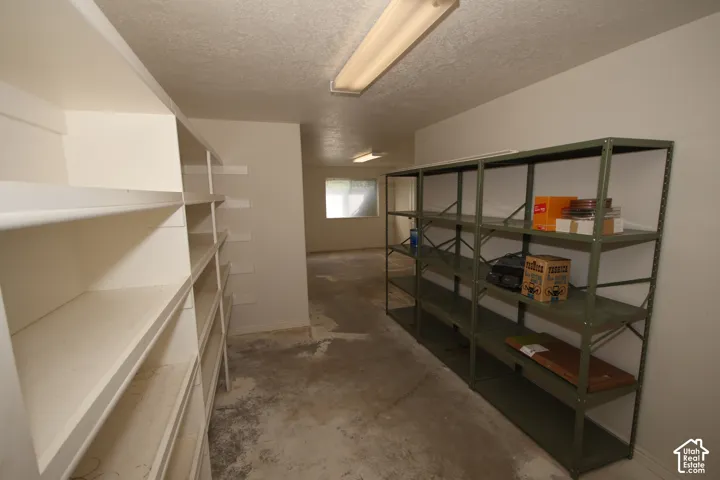 Extensive built-in shelving and additional metal shelving units provide significant storage capacity
