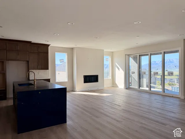 Main floor featuring a chef's kitchen, floor to ceiling fireplace and multi-panel sliding glass door