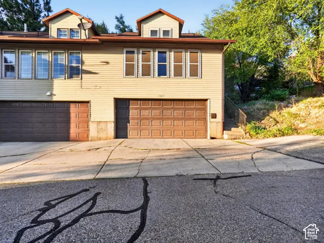 Beige horizontal siding exterior with brown garage doors