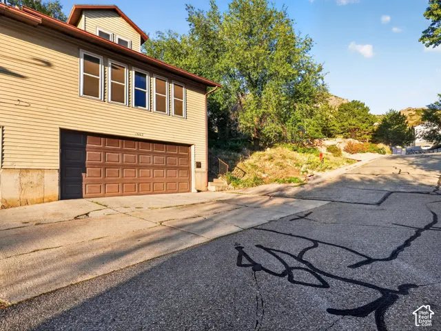 Attached two-car garage with paneling and upper-level windows