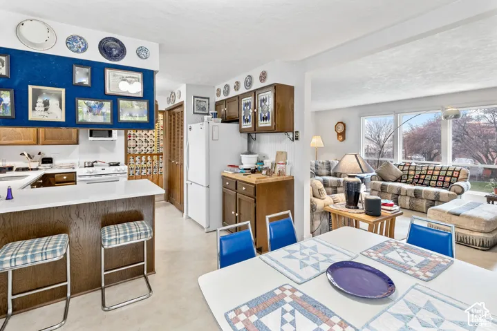 Kitchen featuring white countertops, wood-finish cabinetry, and a white oven/range