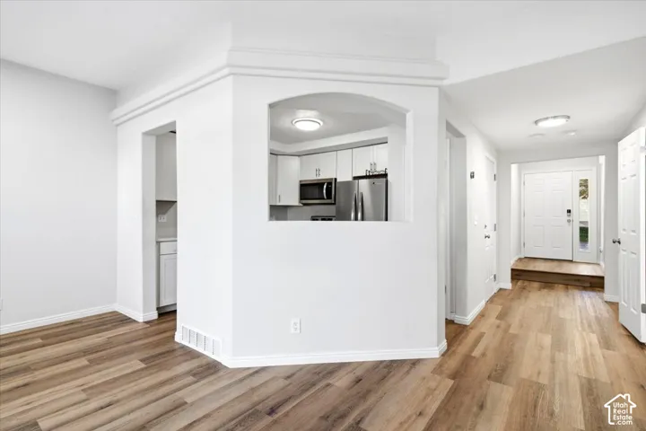 LVP flooring throughout, with a framed archway leading to the kitchen