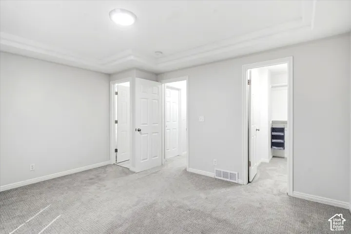 Light gray wall finishes, gray carpet, and white trim