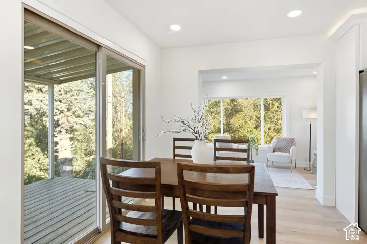 Recessed lighting, wood-finish flooring, sliding glass door, and a large picture window