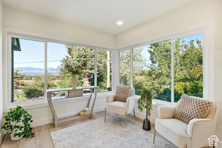 Expansive corner windows showcasing distant mountains and lush greenery