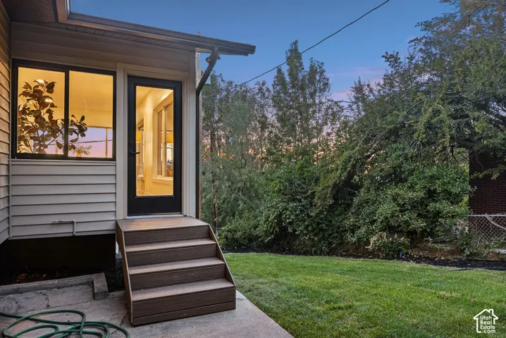 Exterior siding with modern black-framed windows and a full-light door