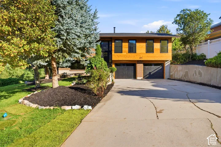 Contemporary exterior featuring wood siding and dark-framed windows