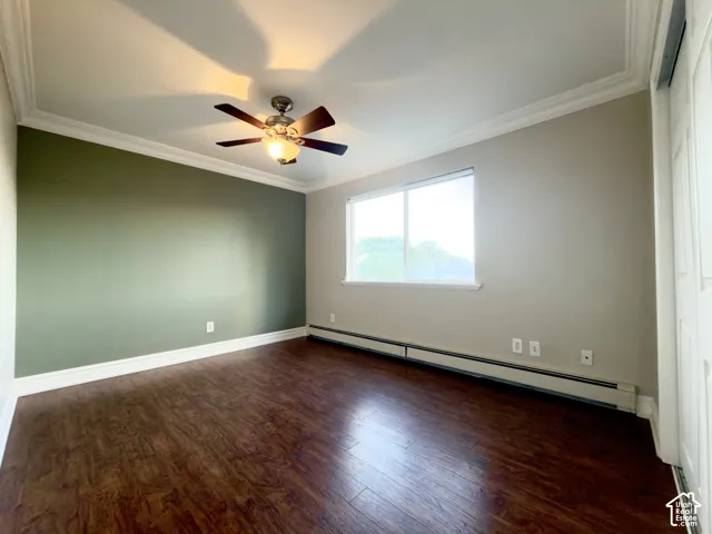 Laminate flooring, crown molding, ceiling fan with integrated lighting, natural light window, and white trim throughout