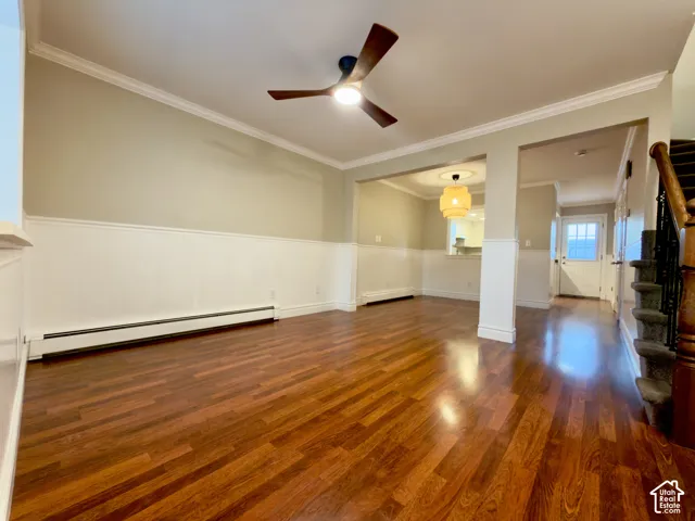 Hardwood-finish flooring, crown molding, wainscoting, ceiling fan, and built-in lighting