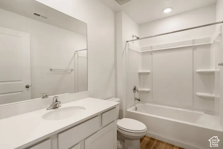 Vanity with an integrated sink, brushed nickel faucet, and a large wall-mounted mirror