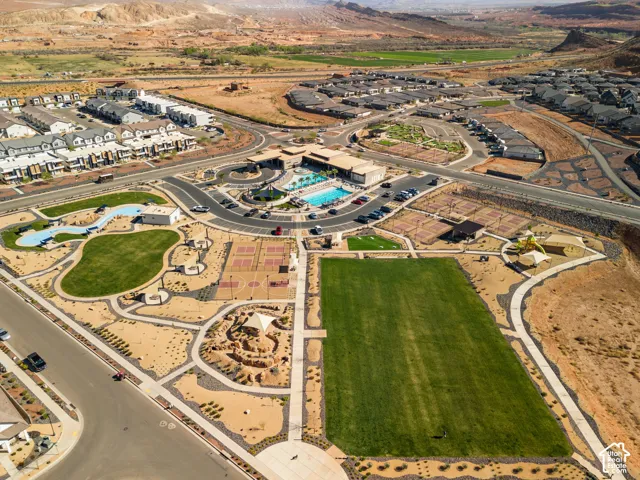 Central community with a large swimming pool, expansive green spaces, multiple sports courts, and pedestrian pathways