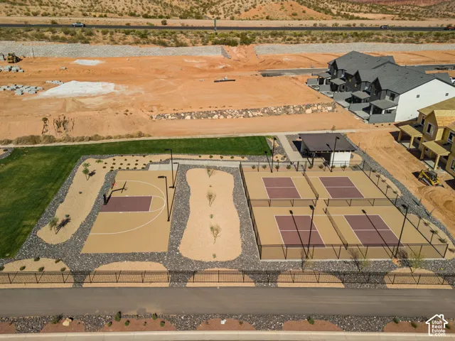 Manicured green space with a basketball court, four pickleball courts, and a shaded pavilion
