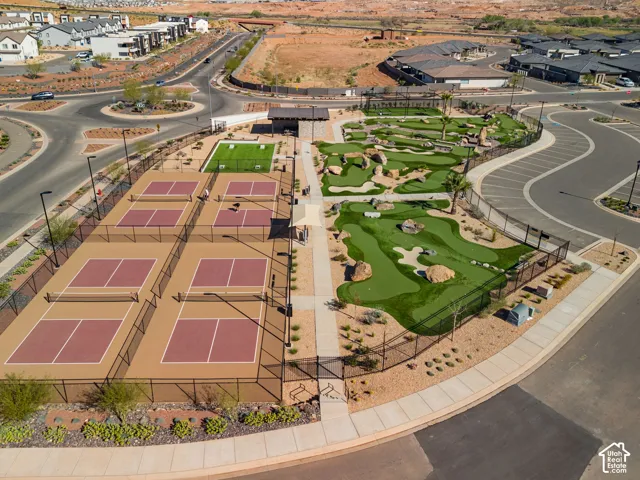 Multiple pickleball courts, expansive mini-golf course, artificial turf activity area, shaded gathering pavilion, and paved walkways