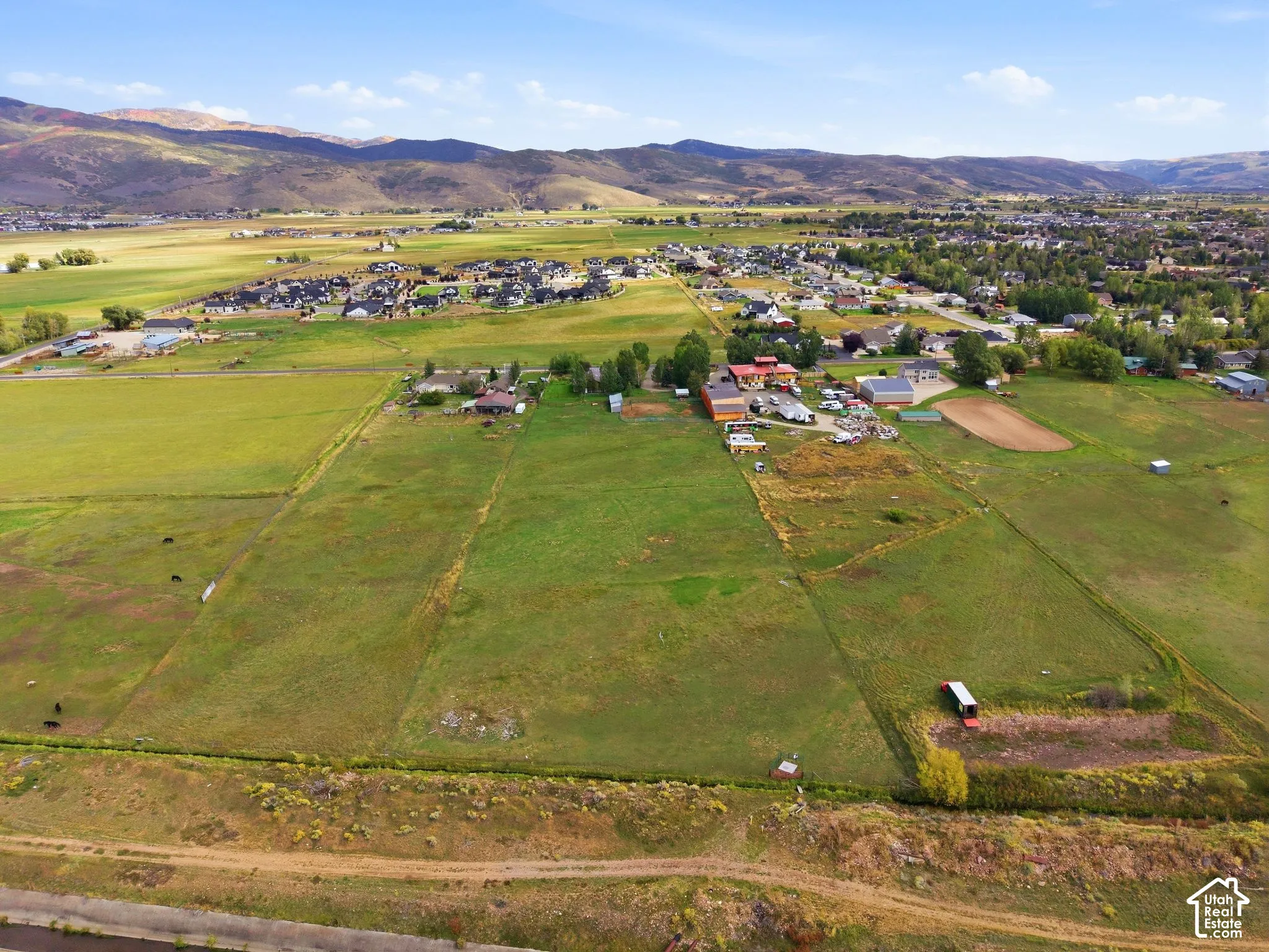 Expansive land parcel featuring open fields and distant mountain scenery