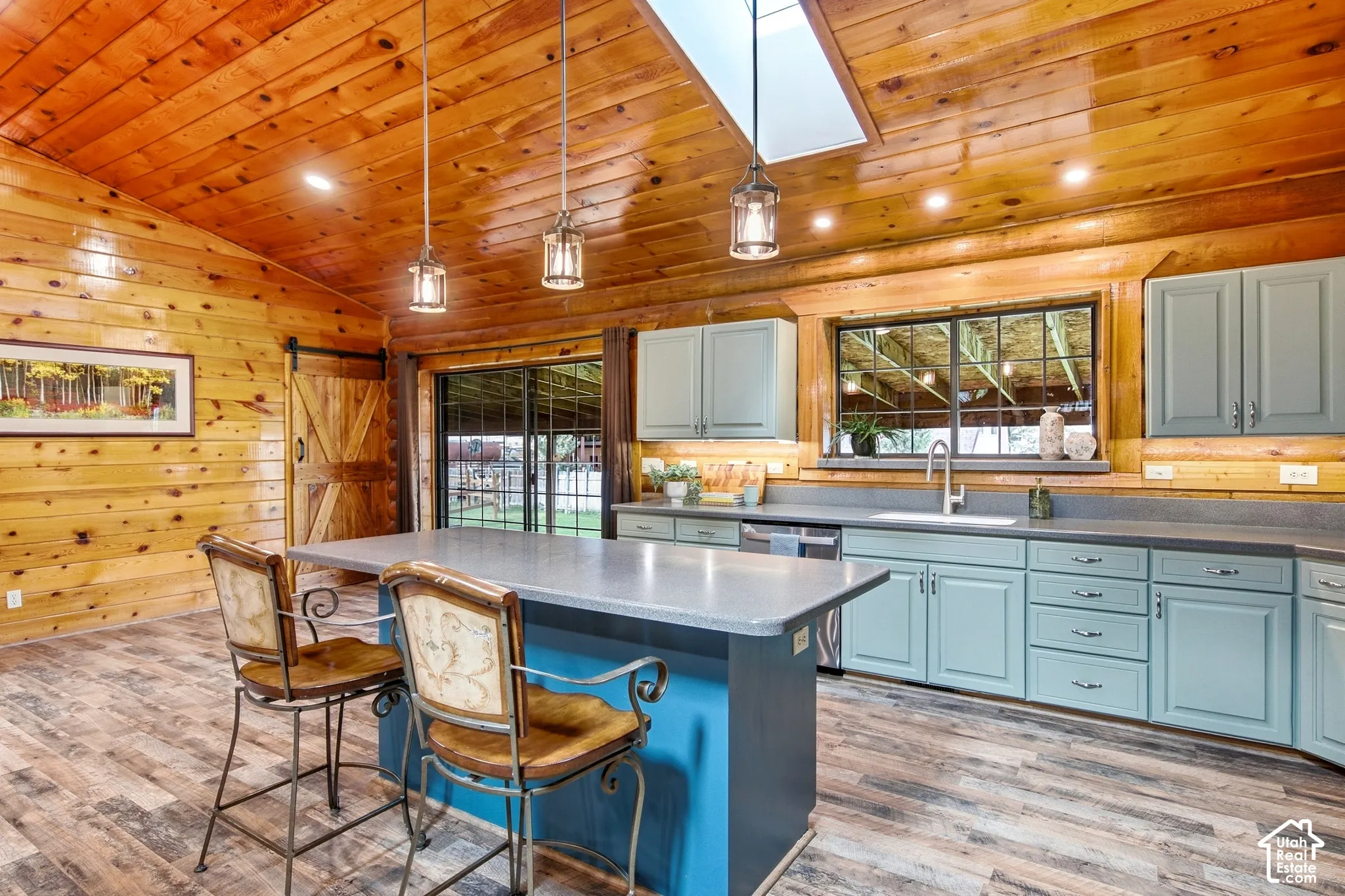 Vaulted wood-paneled ceilings with skylight and recessed lighting
