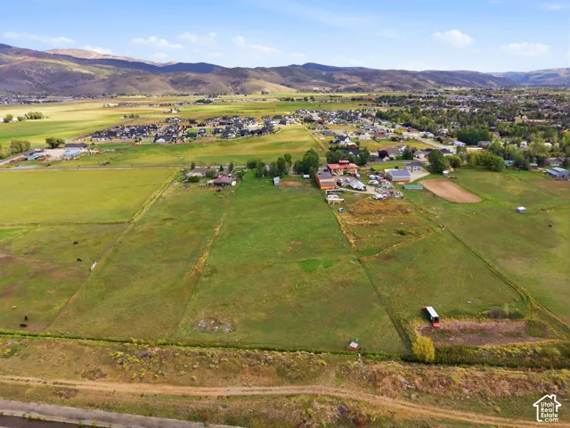 Expansive land parcel featuring open fields and distant mountain scenery