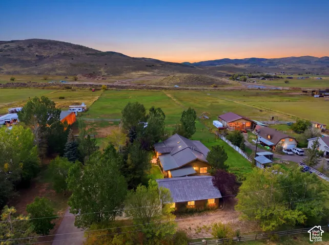 Expansive property featuring multiple structures, mature trees, and agricultural fields