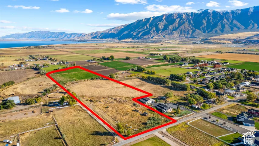 Expansive land parcel featuring open fields and partial tree coverage