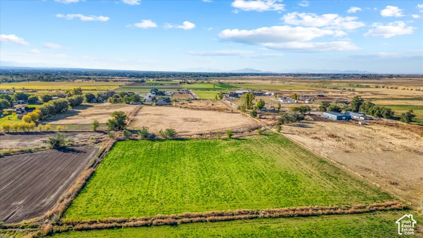 Expansive land parcel featuring cultivated fields and a distant rural landscape