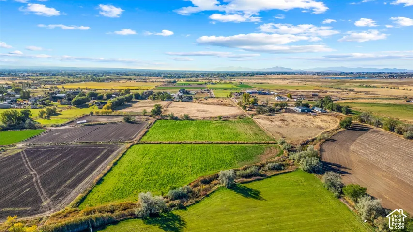 Expansive rural landscape featuring cultivated fields and a distant mountain range