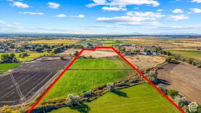 Expansive acreage with cultivated fields and natural vegetation
