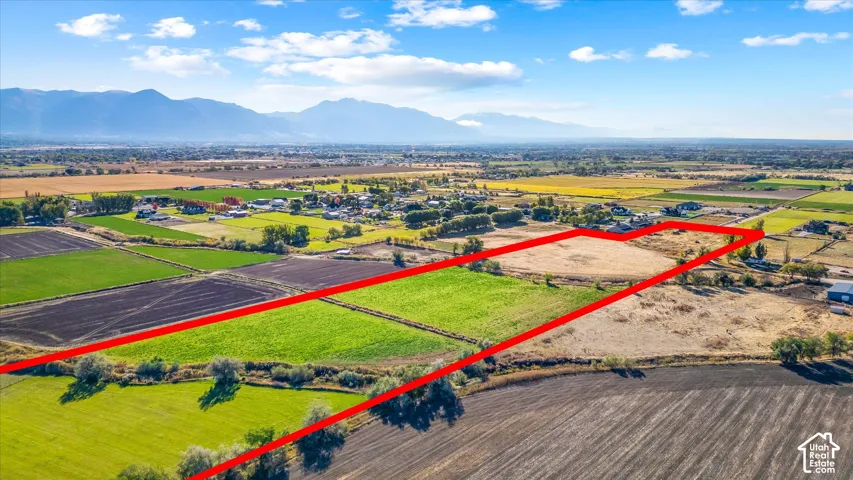Expansive land parcel featuring open fields and distant mountain scenery