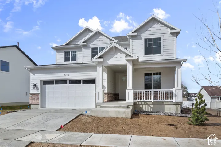 White siding exterior with brick accents