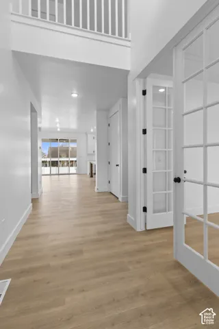 Expansive entryway featuring wood-finish flooring, recessed lighting, and French doors
